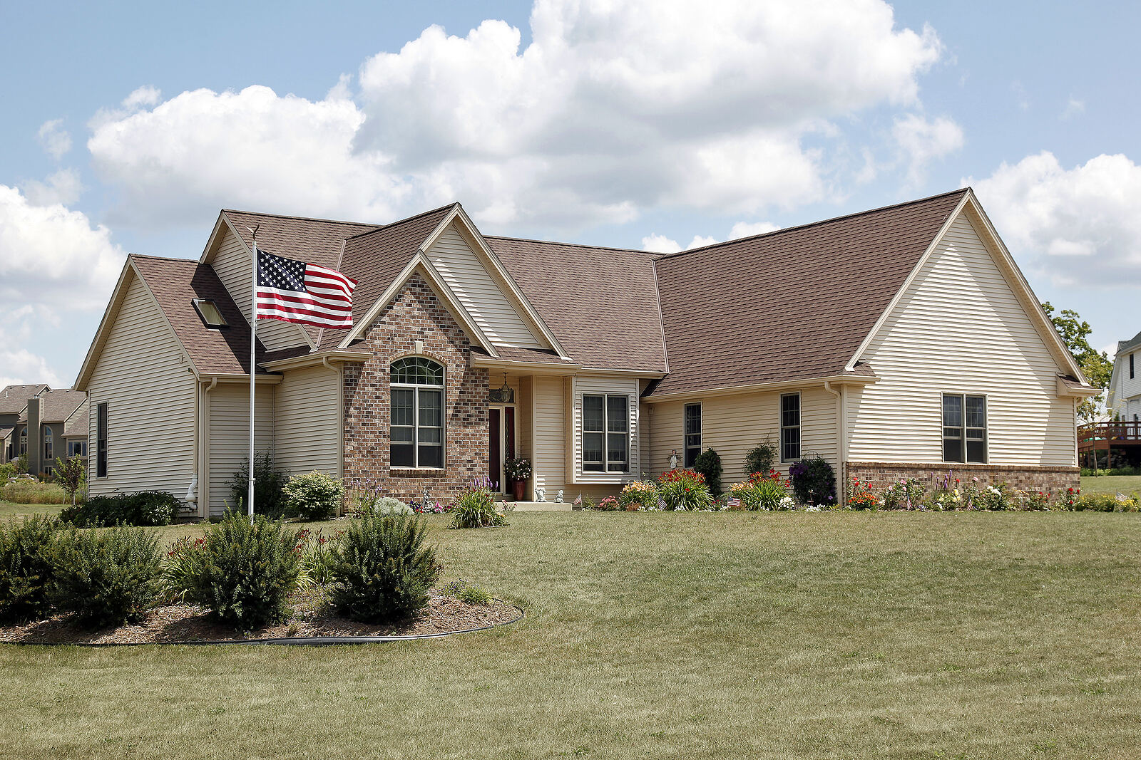 Brick home with a well-maintained roof and custom gutter system