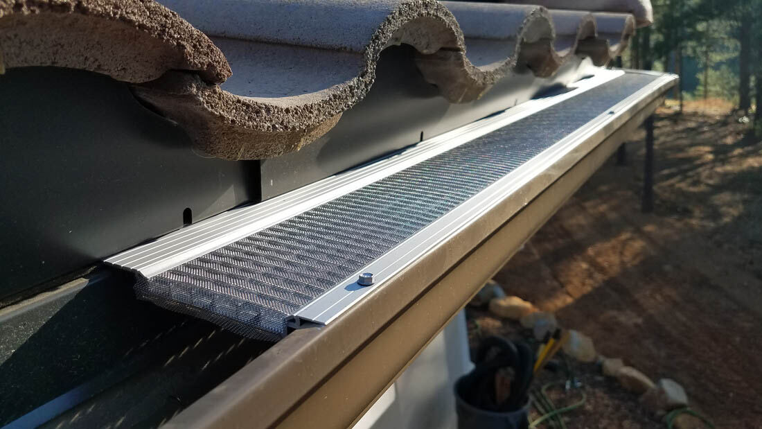Micro-mesh guard partially installed over an open gutter