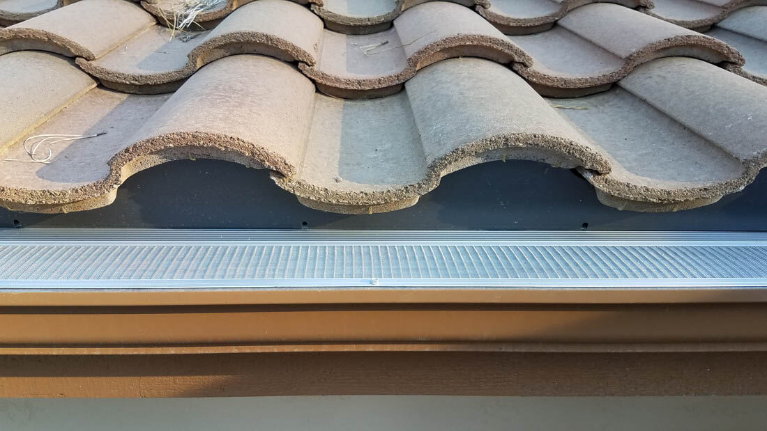 Front view of gutter guards installed along a Tacoma roofline